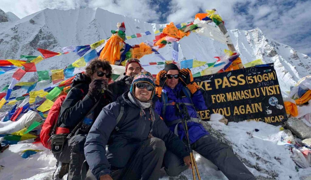 Trekkers infront of Larkya La Pass hoarding board at Manaslu Circuit Trekking in Nepal