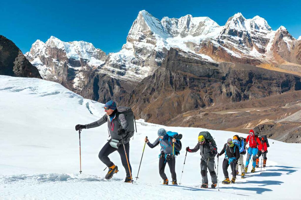 group of people climbing in a mountain in winter season 